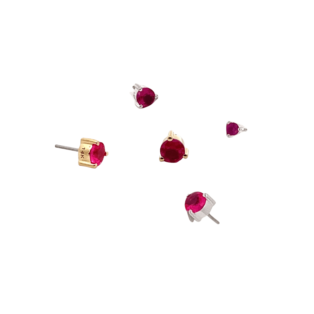 Set of garnet gemstone earrings on a black background