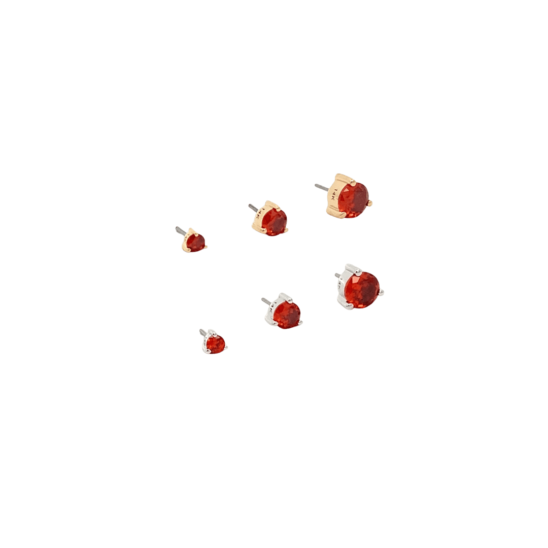 Small red and gold jewelry pieces on a black background