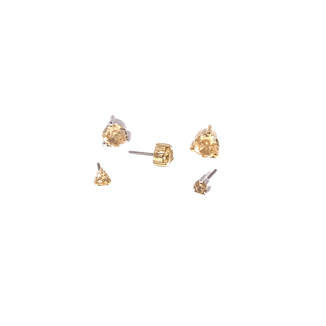 Set of gold earrings on a black background