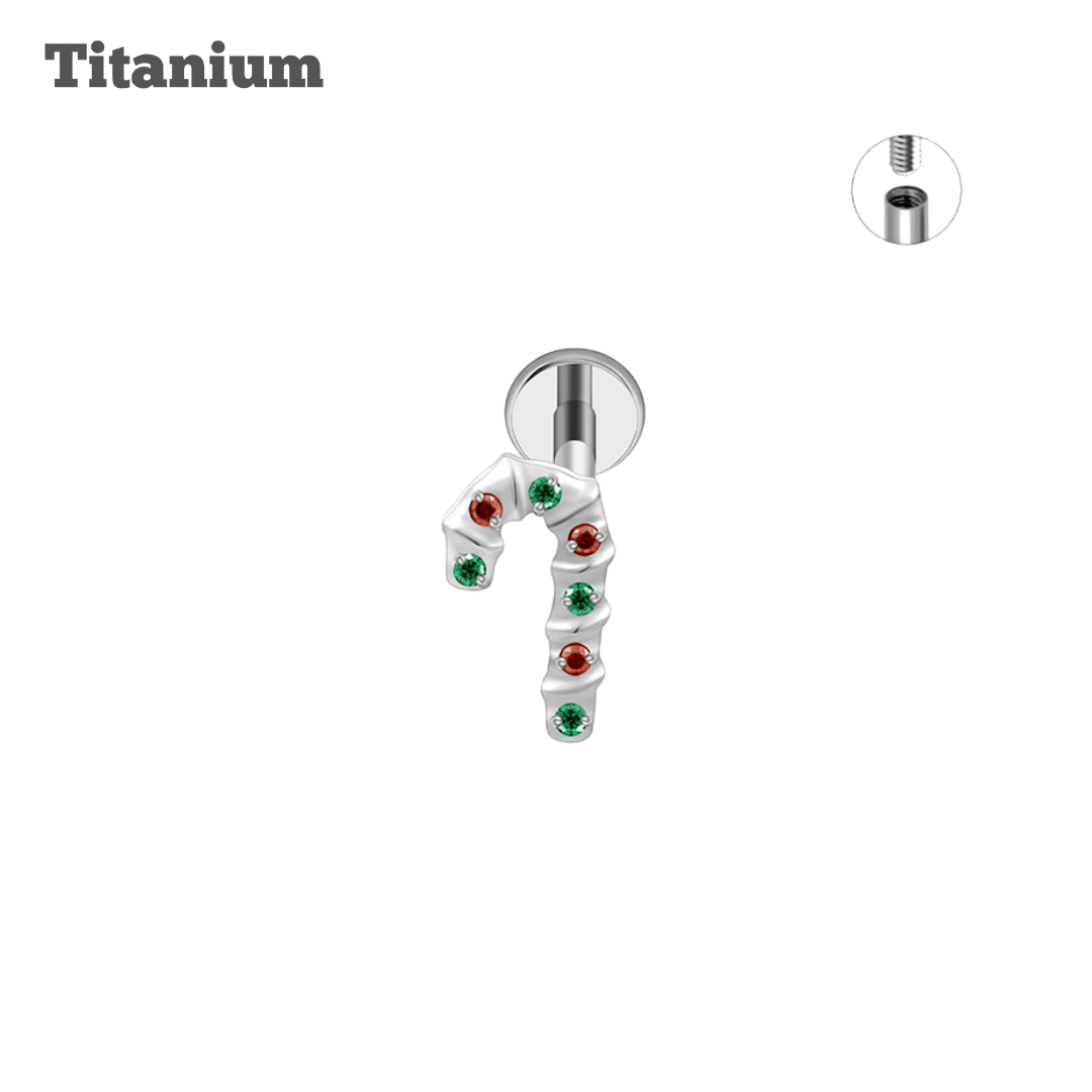 Titanium candy cane shape jewelry piece with colored gemstones on a black background