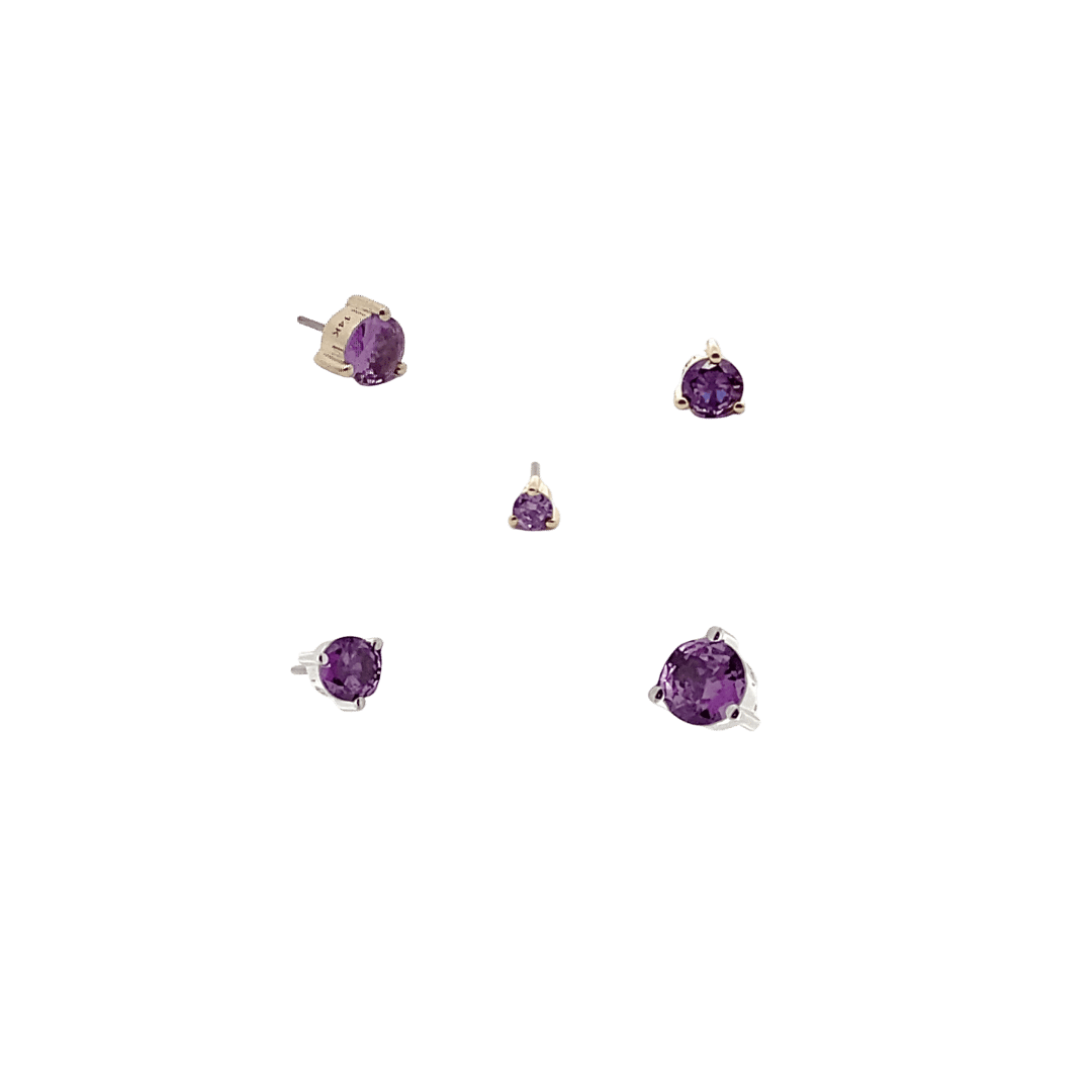 Set of amethyst gemstone earrings on a black background