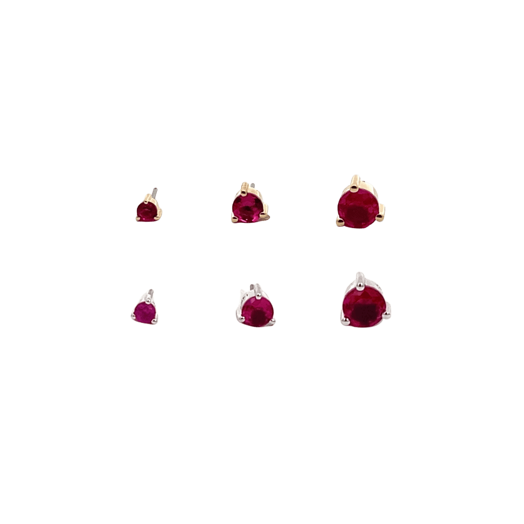 Set of garnet birthstone earrings on a black background