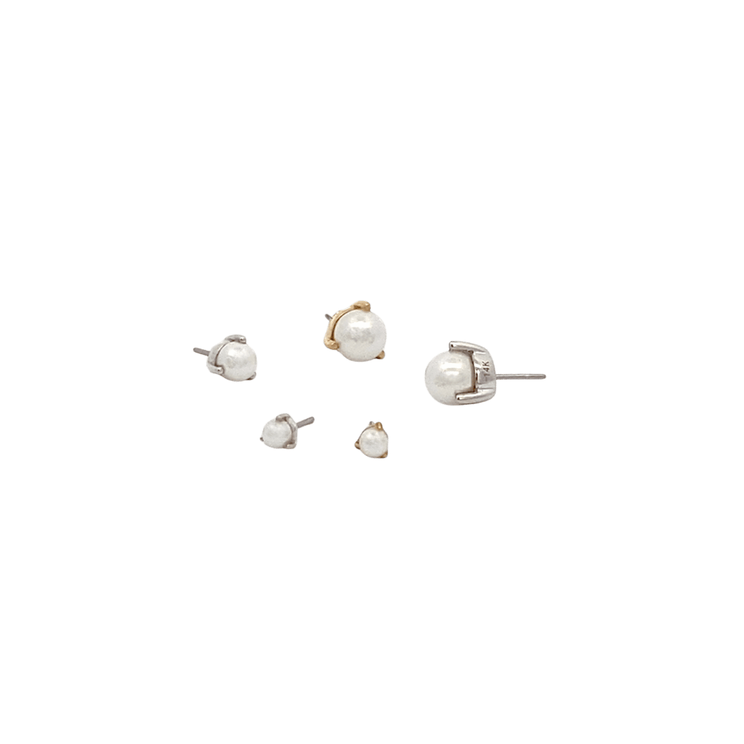 Set of pearl earrings on a black background